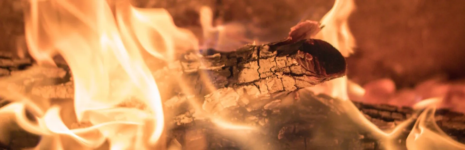 A split log burning in a fire
